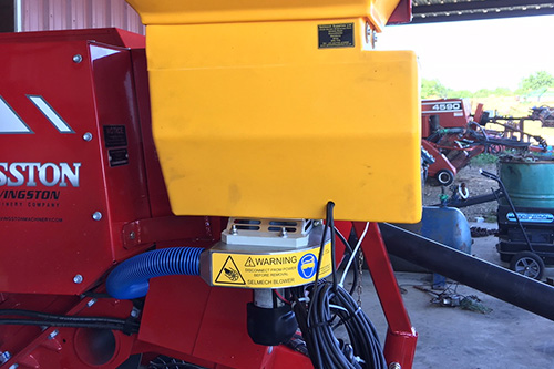 Powdermaster with blower attachment on a baler