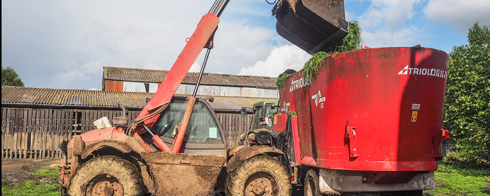 Total mixed ration mixer being loaded